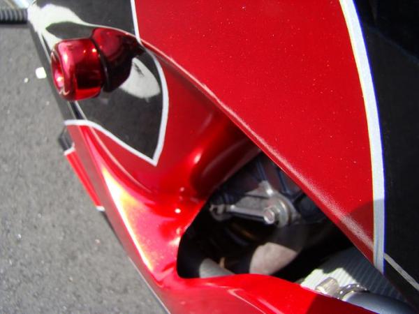 Close up of the rattle can job.  NO those arnt bumps and pits in the paint, its Victory Red Base coat with Red Metal Flake Candy paint over it, finish