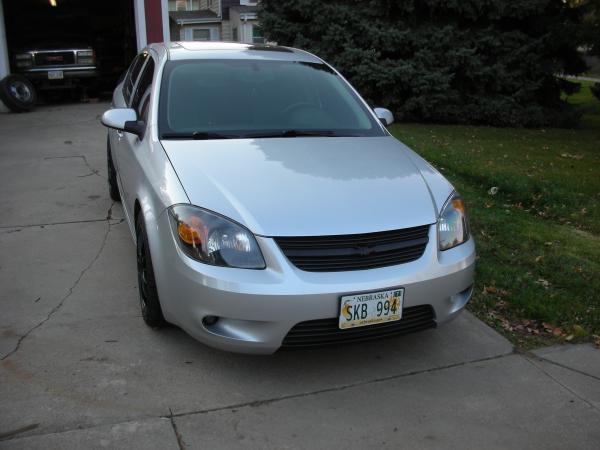 Front end, blacked out lights, matte black vinyl wrap on the grill, with the emblem painted black as well